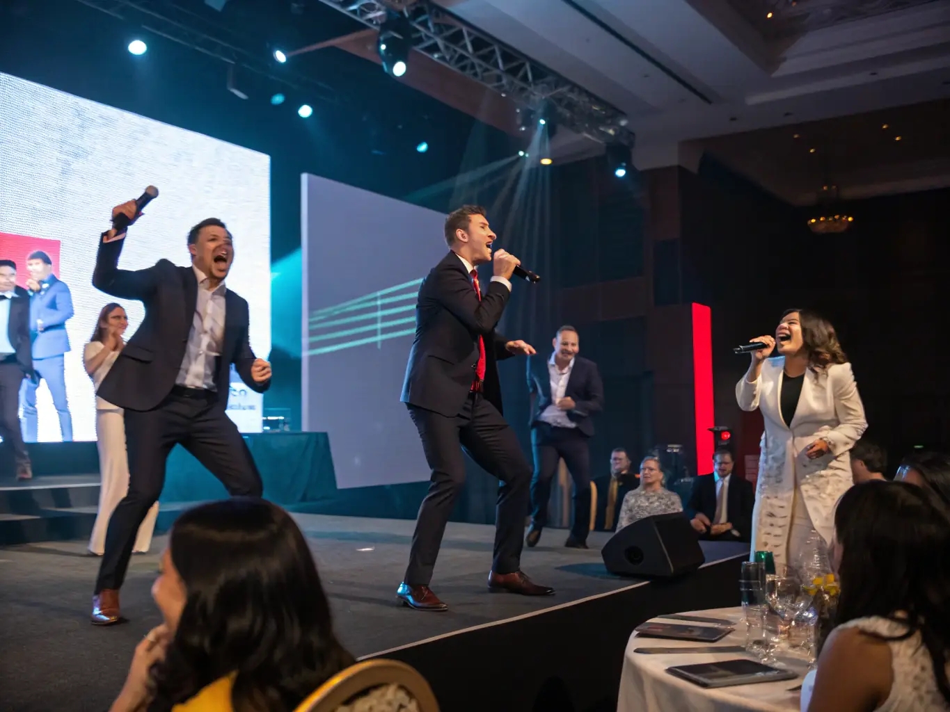 A lively corporate event with dynamic lighting and stage effects, showcasing Event Pro Warszawa's professional production capabilities for corporate events.